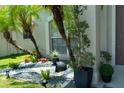 Lush landscaping with palm trees and flowering plants adorn the entrance at 11761 Hatcher Cir, Orlando, FL 32824