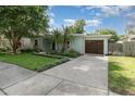 Beautiful home with palm trees, flower boxes and a well-maintained lawn at 1219 Oakley St, Orlando, FL 32806