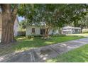 Landscaped home featuring a well-manicured lawn and mature shade trees at 1219 Oakley St, Orlando, FL 32806
