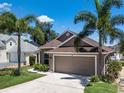 Charming single-story home featuring lush landscaping and a two-car garage at 144 Bridgeton St, Davenport, FL 33896