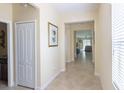 Inviting hallway with neutral paint, tile flooring, and views into the living area at 14845 Speer Lake Dr, Winter Garden, FL 34787