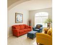 Inviting living room with comfortable seating, arched window, and decorative accents at 1784 Providence Blvd, Deltona, FL 32725