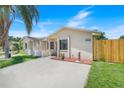 Attractive single-story house showcasing a well-maintained front yard, beige exterior, and a concrete driveway at 1920 Dardanelle Dr, Orlando, FL 32808