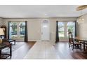 Bright foyer featuring tile flooring, hardwood floors, and large arched windows at 2085 Stone Cross Cir, Orlando, FL 32828