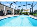 Screened-in pool area featuring lounge chairs and a fountain at 2085 Stone Cross Cir, Orlando, FL 32828