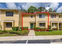 Charming townhouse with manicured landscaping, a green front door, and ample natural light at 2208 Mcmahon Ct # 1033, Orlando, FL 32812
