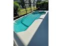 A gorgeous screened-in pool with a spillover spa and white concrete patio at 2505 Osprey Creek Ct, Kissimmee, FL 34747