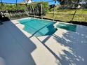 Stunning screened-in pool with white concrete patio and spillover spa at 2505 Osprey Creek Ct, Kissimmee, FL 34747