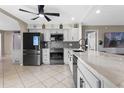 Modern kitchen featuring white cabinets, stainless steel appliances, and a spacious countertop at 2936 Estill St, Deltona, FL 32738