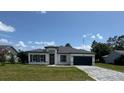 Beautiful single-story home with a modern aesthetic, featuring a garage and landscaped front yard at 482 Marion Oaks Mnr, Ocala, FL 34473