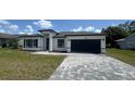 Well-maintained home featuring a two-car garage, updated facade, and inviting curb appeal at 482 Marion Oaks Mnr, Ocala, FL 34473