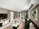 Living room with stylish decor, marble floors, plush sofa, marble coffee table, and a mini-split air conditioner at 4925 Catfish Rd, Lake Wales, FL 33898