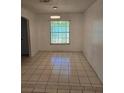Bright dining room with a window, neutral paint, tile flooring and modern lighting at 5396 Lonesome Dove Dr, Kissimmee, FL 34746