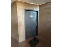 Unit 315 door with a black door mat in a brown hallway at 5725 Gatlin Ave # 315, Orlando, FL 32822