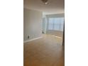 Empty living room with tile floor, white walls and one window with blinds at 5725 Gatlin Ave # 315, Orlando, FL 32822
