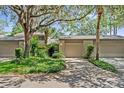 Charming home featuring a two-car garage and lush landscaping surrounded by mature trees at 616 Woodridge Dr, Casselberry, FL 32730