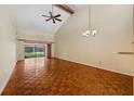Spacious living room featuring gleaming wood floors, vaulted ceiling, and natural light at 616 Woodridge Dr, Casselberry, FL 32730