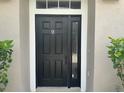 Stylish front door with sidelight and transom window welcomes you home at 6416 S Goldenrod Rd # 8A, Orlando, FL 32822