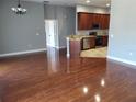 Spacious living room featuring hardwood floors adjacent to the kitchen area at 6416 S Goldenrod Rd # 8A, Orlando, FL 32822