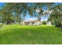 Single-story home with green shutters and a spacious yard at 6720 Midland Drive, St Cloud, FL 34771
