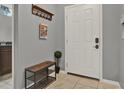 Charming entryway featuring a bench, coat rack, and bright white door at 8977 Majesty Palm Rd, Kissimmee, FL 34747