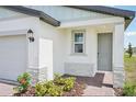 Welcoming home entrance with a brick-paved path, stylish front door, and decorative stone accents at 903 Donahue Pass, Lake Hamilton, FL 33851