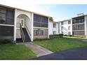 Condo complex with a landscaped lawn with covered screened in patios at 954 Courtyard Ln # 52, Orlando, FL 32825