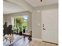 Bright foyer with tile flooring and a view of the landscaped yard at 1165 Indian Ridge E Trl, Kissimmee, FL 34747
