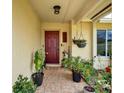 Inviting front porch with decorative plants and tile flooring at 1165 Indian Ridge E Trl, Kissimmee, FL 34747