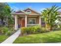 Beautiful home with a quaint front porch, well-maintained lawn, and lush landscaping at 12868 Holdenbury Ln, Windermere, FL 34786