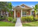 Attractive home with manicured lawn, walkway, colorful garden and welcoming front porch with pillars at 12868 Holdenbury Ln, Windermere, FL 34786