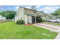 Charming townhome with a green tile roof, lush front yard, and brick-lined driveway at 1301 Winter Green Way, Winter Garden, FL 34787