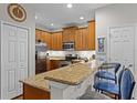 Open-concept kitchen featuring granite countertops and stainless steel appliances at 14242 Desert Haven St # Ge, Windermere, FL 34786