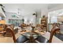 Open-plan dining area with large glass table, decorative plants, and views of the main living area at 1430 Challenger Ave, Davenport, FL 33897
