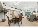 Bright living area featuring high ceilings, a decorative shelf, and an adjacent dining space at 1430 Challenger Ave, Davenport, FL 33897