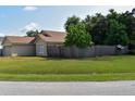 Well-maintained yard with lush green grass and a privacy fence surrounding the property at 1436 Swan Ct, Kissimmee, FL 34759