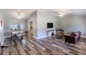 Open-concept living and dining area with stylish gray flooring, ample natural light, and modern ceiling fans at 2005 Dalton Ave, Deltona, FL 32725