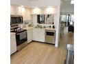 Modern kitchen with stainless steel appliances and a passthrough window to dining and living area at 2480 Tahoe Cir # 2480, Winter Park, FL 32792