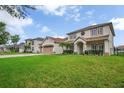 Charming home with a well-manicured lawn, a two-car garage, and lush palm trees at 2507 Water Valley Dr, St Cloud, FL 34771