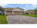 Lovely two-story home featuring a three-car garage and brick paver driveway at 2507 Water Valley Dr, St Cloud, FL 34771