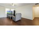Bright living room with wood floors, a comfortable recliner, and natural light from the windows at 2791 L B Mcleod Rd # C, Orlando, FL 32805