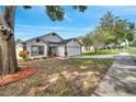 Charming single-story home with a well-manicured lawn and colorful landscaping at 280 Bay St, Apopka, FL 32712