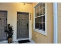 Close-up of unit entrance with a gray door, a window and address number at 2820 Oakwater Dr # 2820, Kissimmee, FL 34747