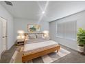 Cozy bedroom with a wooden bed frame, soft lighting, and a large window for natural light at 326 Charles Dr, Deland, FL 32724