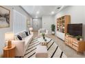 Bright living room featuring a modern design with neutral tones, striped accents, and stylish furniture at 326 Charles Dr, Deland, FL 32724