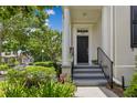 View of the front door with landscaping and a staircase leading up to the entrance at 3798 Lower Union Rd, Orlando, FL 32814