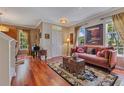 Cozy living room with hardwood floors, elegant furnishings, and plenty of natural light at 3798 Lower Union Rd, Orlando, FL 32814