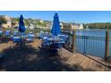 Outdoor deck overlooking a serene lake with seating, umbrellas, and community views at 4019 Venetian Bay Dr # 107, Kissimmee, FL 34741
