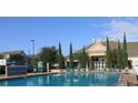Community pool with ample seating, manicured landscaping, and easy access to community amenities at 4019 Venetian Bay Dr # 107, Kissimmee, FL 34741