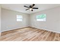 Light-filled bedroom showcasing new floors, neutral walls, and two windows for ample natural light at 5021 Saint Marie Ave, Belle Isle, FL 32812
